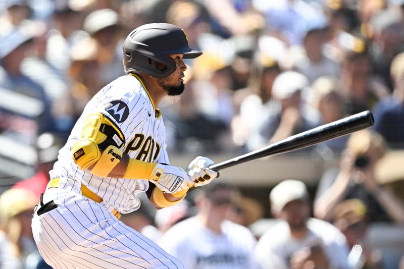 Sep 24, 2025; San Diego, California, USA; San Diego Padres first baseman Luis Arraez (4) hits a single during the first inning against the Milwaukee Brewers at Petco Park. Mandatory Credit: Denis Poroy-Imagn Images