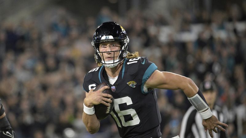 Jacksonville Jaguars quarterback Trevor Lawrence (16) scrambles for yardage during the first half of an NFL football game against the Cincinnati Bengals, Monday, Dec. 4, 2023, in Jacksonville, Fla. (AP Photo/Phelan M. Ebenhack)