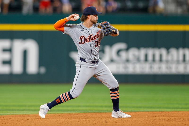 Jun 4, 2024; Arlington, Texas, USA; Detroit Tigers shortstop Zach McKinstry (39) fields a ground ball during the ninth inning against the Texas Rangers at Globe Life Field. Mandatory Credit: Andrew Dieb-USA TODAY Sports