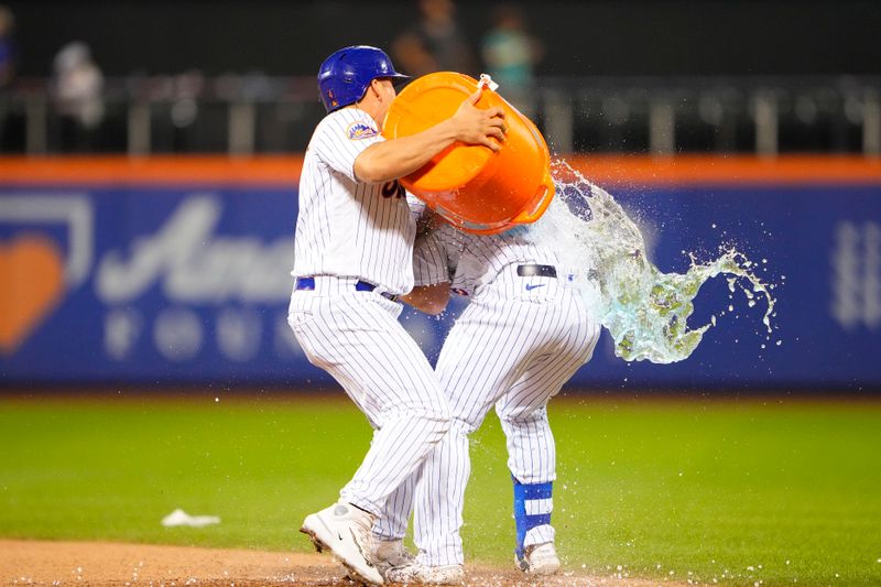 Aug 30, 2023; New York City, New York, USA; New York Mets designated hitter Francisco Alvarez (4) dumps gatorade over  right fielder DJ Steward (29) for winning the game against the Texas Rangers at Citi Field. Mandatory Credit: Gregory Fisher-USA TODAY Sports