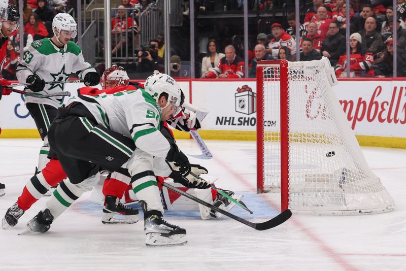 Dec 3, 2025; Newark, New Jersey, USA; Dallas Stars right wing Mikko Rantanen (96) scores a goal on New Jersey Devils goaltender Jacob Markstrom (25) during the third period at Prudential Center. Mandatory Credit: Ed Mulholland-Imagn Images