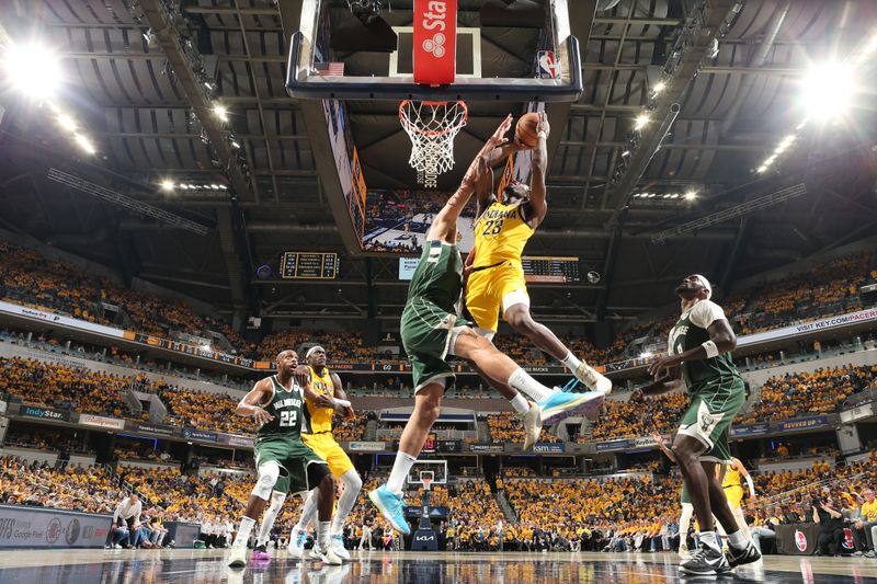 INDIANAPOLIS, IN - APRIL 26: Aaron Nesmith #23 of the Indiana Pacers drives to the basket during the game against the Milwaukee Bucks during Round 1 Game 3 of the 2024 NBA Playoffs on April 26, 2024 at Gainbridge Fieldhouse in Indianapolis, Indiana. NOTE TO USER: User expressly acknowledges and agrees that, by downloading and or using this Photograph, user is consenting to the terms and conditions of the Getty Images License Agreement. Mandatory Copyright Notice: Copyright 2023 NBAE (Photo by Nathaniel S. Butler/NBAE via Getty Images)