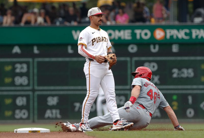 Jul 4, 2024; Pittsburgh, Pennsylvania, USA; St. Louis Cardinals first baseman Paul Goldschmidt (46) steals second base without a throw as Pittsburgh Pirates second baseman Nick Gonzales (39) looks on during the fourth inning at PNC Park. Mandatory Credit: Charles LeClaire-USA TODAY Sports