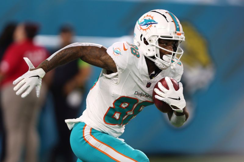 Miami Dolphins wide receiver Keke Coutee (88) runs on a kickoff return during the second half of an NFL preseason football game against the Jacksonville Jaguars, Saturday, Aug. 26, 2023, in Jacksonville, Fla. (AP Photo/Gary McCullough)