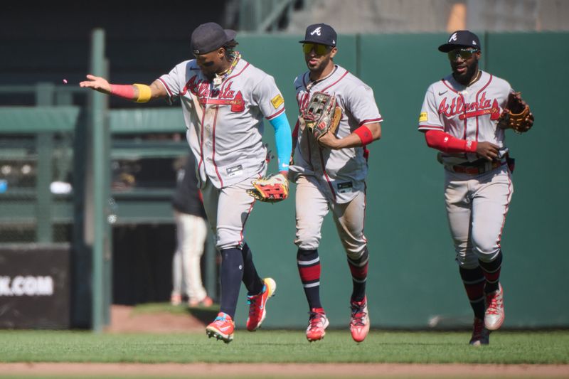 Aug 26, 2023; San Francisco, California, USA; Atlanta Braves outfielder Ronald Acuna Jr. (13) throws his chewing gum and runs in from the outfield with outfielders Eddie Rosario (8) and Michael Harris II (23) after the last out of the ninth inning against the San Francisco Giants at Oracle Park.  Mandatory Credit: Robert Edwards-USA TODAY Sports