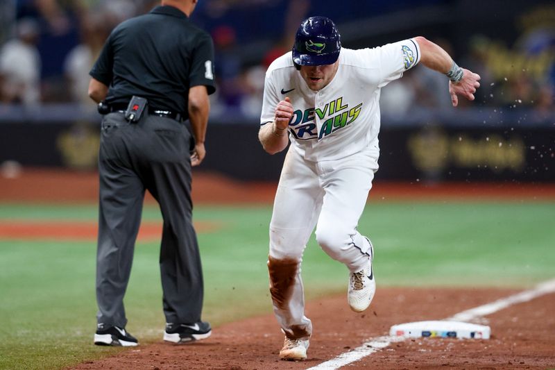 May 19, 2023; St. Petersburg, Florida, USA;  Tampa Bay Rays first baseman Luke Raley (55) scores a run on a sacrifice fly ball from Tampa Bay Rays catcher Francisco Mejia (21) (not pictured) against the Milwaukee Brewers in the eight inning at Tropicana Field. Mandatory Credit: Nathan Ray Seebeck-USA TODAY Sports