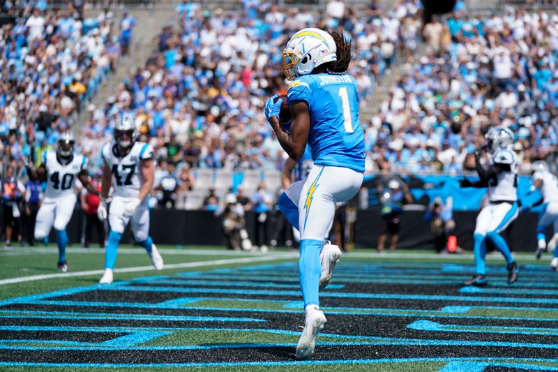 Los Angeles Chargers wide receiver Quentin Johnston scores during the first half of an NFL football game against the Carolina Panthers on Sunday, Sept. 15, 2024, in Charlotte, N.C. (AP Photo/Erik Verduzco)