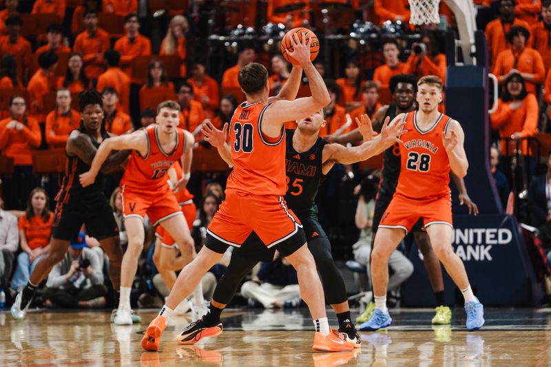 Feb 21, 2026; Charlottesville, Virginia, USA; Virginia Cavaliers guard Dallin Hall (30) controls the ball while Miami (FL) Hurricanes guard Dante Allen (35) defends during the first half at John Paul Jones Arena. Mandatory Credit: Emily Faith Morgan-Imagn Images
