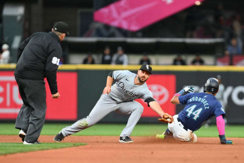 Jun 11, 2024; Seattle, Washington, USA; Chicago White Sox shortstop Paul DeJong (29) misses the tag on Seattle Mariners center fielder Julio Rodriguez (44) for a stolen base during the fifth inning at T-Mobile Park. Mandatory Credit: Steven Bisig-USA TODAY Sports