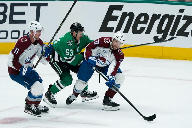 Apr 19, 2025; Dallas, Texas, USA; Colorado Avalanche left wing Jonathan Drouin (27) works the puck up ice as Dallas Stars right wing Evgenii Dadonov (63) defends during the first period in game one of the first round of the 2025 Stanley Cup Playoffs at American Airlines Center. Mandatory Credit: Raymond Carlin III-Imagn Images