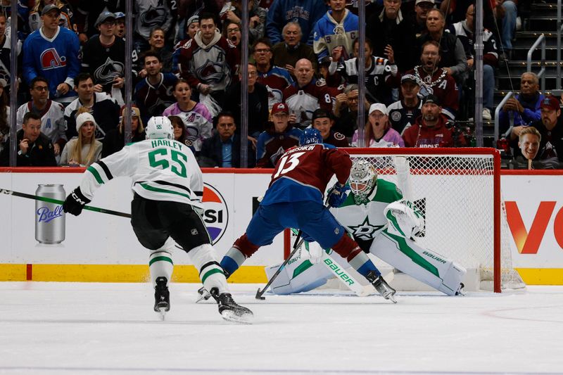 Apr 23, 2025; Denver, Colorado, USA; Colorado Avalanche right wing Valeri Nichushkin (13) controls the puck against Dallas Stars goaltender Jake Oettinger (29) as defenseman Thomas Harley (55) looks on in the first period in game three of the first round of the 2025 Stanley Cup Playoffs at Ball Arena. Mandatory Credit: Isaiah J. Downing-Imagn Images