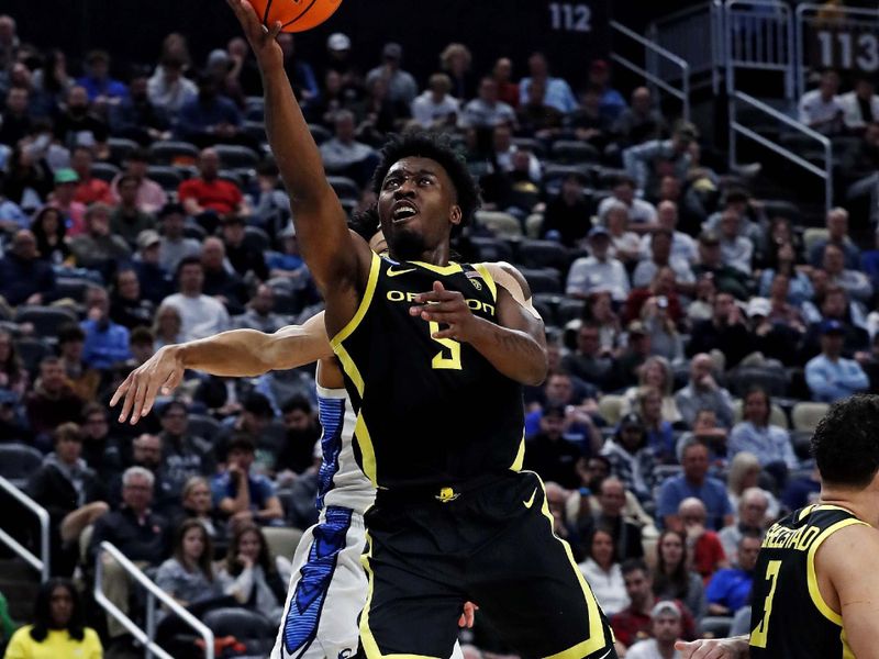 Mar 23, 2024; Pittsburgh, PA, USA; Oregon Ducks guard Jermaine Couisnard (5) shoots the ball against Creighton Bluejays guard Trey Alexander (23) during the second half in the second round of the 2024 NCAA Tournament at PPG Paints Arena. Mandatory Credit: Charles LeClaire-USA TODAY Sports