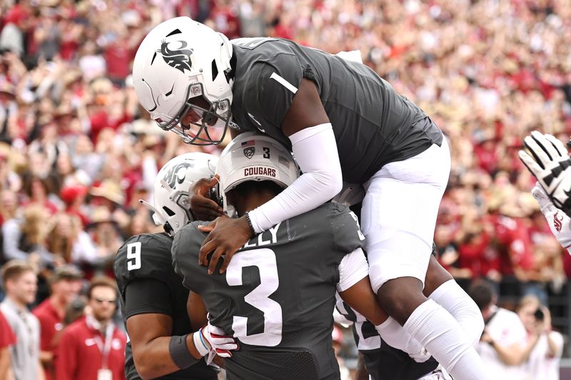 Sep 23, 2023; Pullman, Washington, USA; Washington State Cougars quarterback Cameron Ward (1) jumps on Washington State Cougars wide receiver Josh Kelly (3) after scoring a touchdown against the Oregon State Beavers in the first half at Gesa Field at Martin Stadium. Mandatory Credit: James Snook-USA TODAY Sports