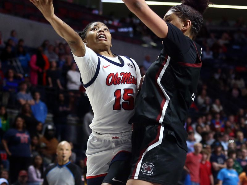 Feb 19, 2023; Oxford, Mississippi, USA; Mississippi Rebels guard Angel Baker (15) drives to the basket as South Carolina Gamecocks center Kamilla Cardoso (10) defends during overtime at The Sandy and John Black Pavilion at Ole Miss. Mandatory Credit: Petre Thomas-USA TODAY Sports