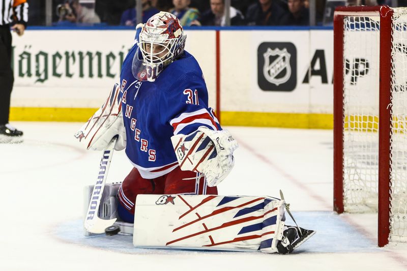 May 5, 2024; New York, New York, USA; New York Rangers goaltender Igor Shesterkin (31) makes a save on a shot on goal attempt in the first period against the Carolina Hurricanes in game one of the second round of the 2024 Stanley Cup Playoffs at Madison Square Garden. Mandatory Credit: Wendell Cruz-USA TODAY Sports