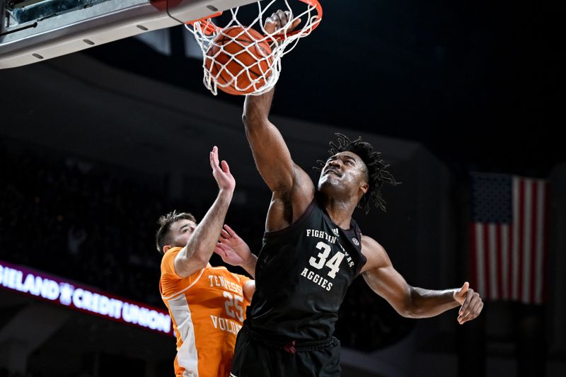 Feb 21, 2023; College Station, Texas, USA;  Texas A&M Aggies forward Julius Marble (34) dunks against Tennessee Volunteers guard Santiago Vescovi (25) during the second half at Reed Arena. Mandatory Credit: Maria Lysaker-USA TODAY Sports