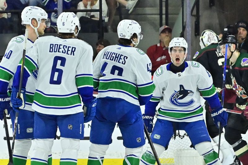 Apr 3, 2024; Tempe, Arizona, USA; Vancouver Canucks defenseman Quinn Hughes (43) celebrates with right wing Conor Garland (8) right wing Brock Boeser (6) and center Elias Pettersson (40) after scoring a goal in the second period against the Arizona Coyotes at Mullett Arena. Mandatory Credit: Matt Kartozian-USA TODAY Sports