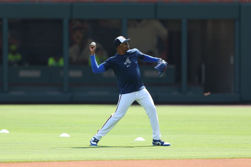 Apr 20, 2024; Cumberland, Georgia, USA; Atlanta Braves relief pitcher Raisel Iglesias (26) throws before game against the Texas Rangers at Truist Park. Mandatory Credit: Mady Mertens-USA TODAY Sports