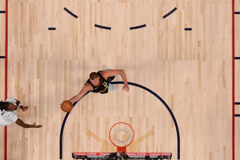 DENVER, CO - MAY 19: Nikola Jokic #15 of the Denver Nuggets rebounds the ball during the game  against the Minnesota Timberwolves during Round 2 Game 7 of the 2024 NBA Playoffs on May 19, 2024 at the Ball Arena in Denver, Colorado. NOTE TO USER: User expressly acknowledges and agrees that, by downloading and/or using this Photograph, user is consenting to the terms and conditions of the Getty Images License Agreement. Mandatory Copyright Notice: Copyright 2023 NBAE (Photo by Bart Young/NBAE via Getty Images)