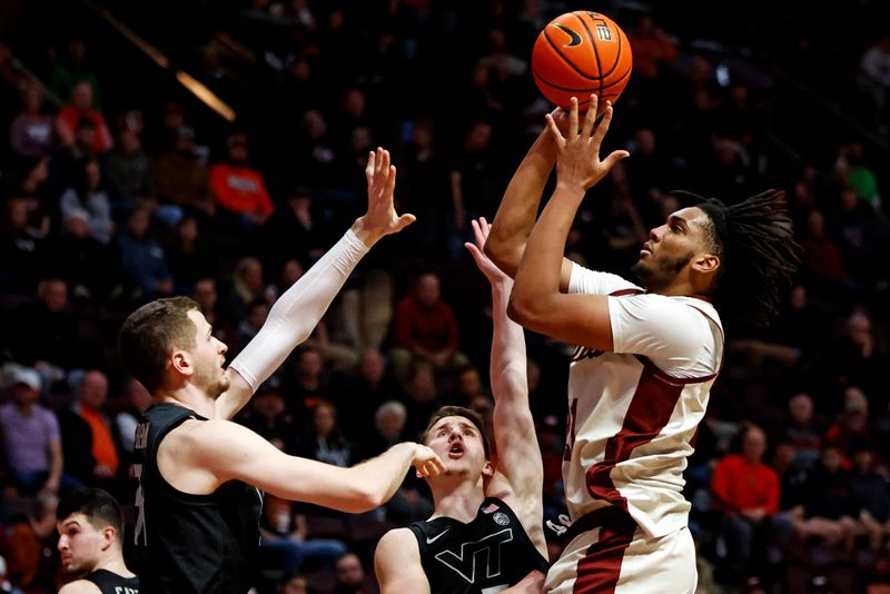 Jan 23, 2024; Blacksburg, Virginia, USA; Boston College Eagles forward Devin McGlockton (21) shoots the ball against Virginia Tech Hokies forward Robbie Beran (31) during the first half at Cassell Coliseum. Mandatory Credit: Peter Casey-USA TODAY Sports