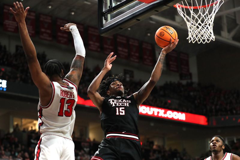 Feb 24, 2025; Lubbock, Texas, USA;  Texas Tech Red Raiders forward JT Toppin (15) goes to the basket against Houston Cougars forward J’Wan Roberts (13) in the second half at United Supermarkets Arena. Mandatory Credit: Michael C. Johnson-Imagn Images
