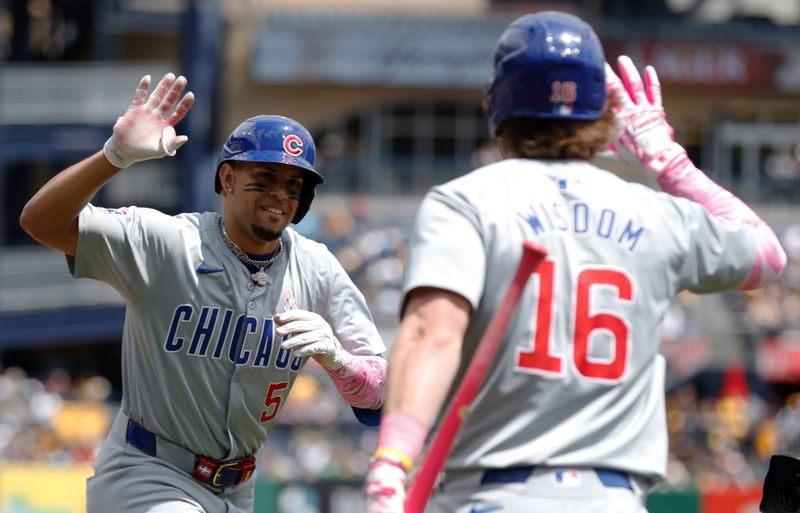 May 12, 2024; Pittsburgh, Pennsylvania, USA;  Chicago Cubs third baseman Christopher Morel (5) celebrates his two run home run with firs baseman Patrick Wisdom (16)  against the Pittsburgh Pirates during the first inning at PNC Park. Mandatory Credit: Charles LeClaire-USA TODAY Sports