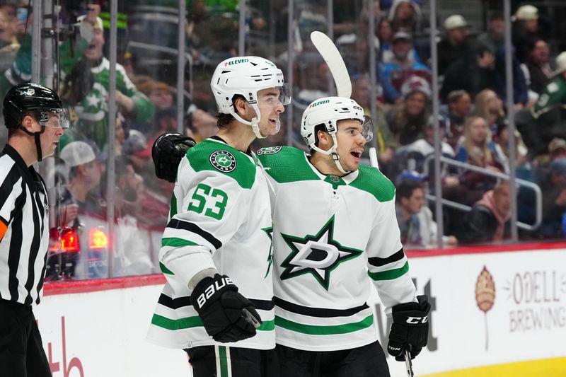 Apr 7, 2024; Denver, Colorado, USA; Dallas Stars center Wyatt Johnston (53) (left) celebrates his goal with center Logan Stankoven (11) in the third period against the Colorado Avalanche at Ball Arena. Mandatory Credit: Ron Chenoy-USA TODAY Sports