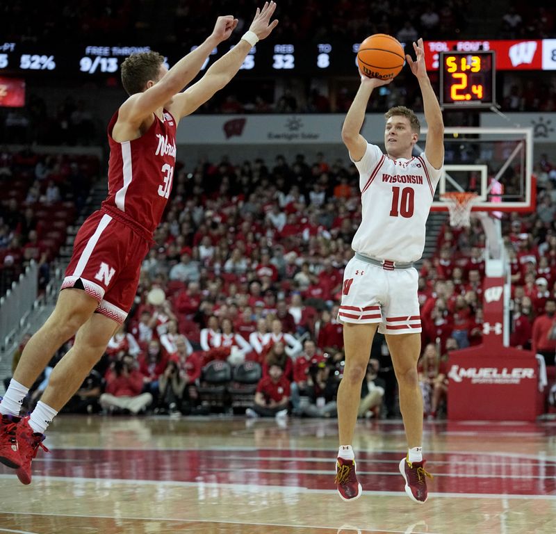 Jan 6, 2024; Madison, Wisconsin, USA; Wisconsin guard Isaac Lindsey (10) shoots over Nebraska guard Cale Jacobsen (31) during the second half at Kohl Center. Mandatory Credit: Mark Hoffman-USA TODAY Sports