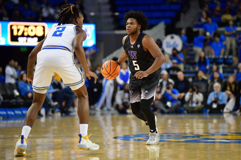 January 14, 2024; Los Angeles, California, USA; Washington Huskies guard Sahvir Wheeler (5) controls the ball against UCLA Bruins guard Dylan Andrews (2) during the first half at Pauley Pavilion. Mandatory Credit: Gary A. Vasquez-USA TODAY Sports