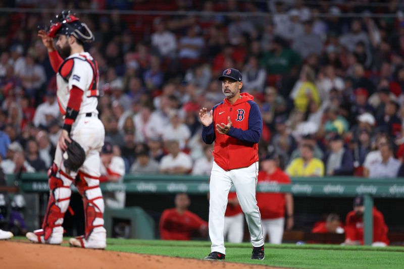 Sep 10, 2024; Boston, Massachusetts, USA; Boston Red Sox manager Alex Cora (13) walks to the mound during the seventh inning against the Baltimore Orioles at Fenway Park. Mandatory Credit: Paul Rutherford-Imagn Images