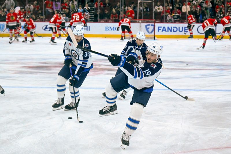 Jan 19, 2026; Chicago, Illinois, USA;  Winnipeg Jets center Jonathan Toews (19) warms up with teammates before the game against the Chicago Blackhawks at United Center. Mandatory Credit: Matt Marton-Imagn Images