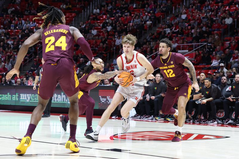 Feb 10, 2024; Salt Lake City, Utah, USA; Utah Utes guard Cole Bajema (2) goes between defenders Arizona State Sun Devils guard Frankie Collins (1) and guard Jose Perez (12) during the second half at Jon M. Huntsman Center. Mandatory Credit: Rob Gray-USA TODAY Sports