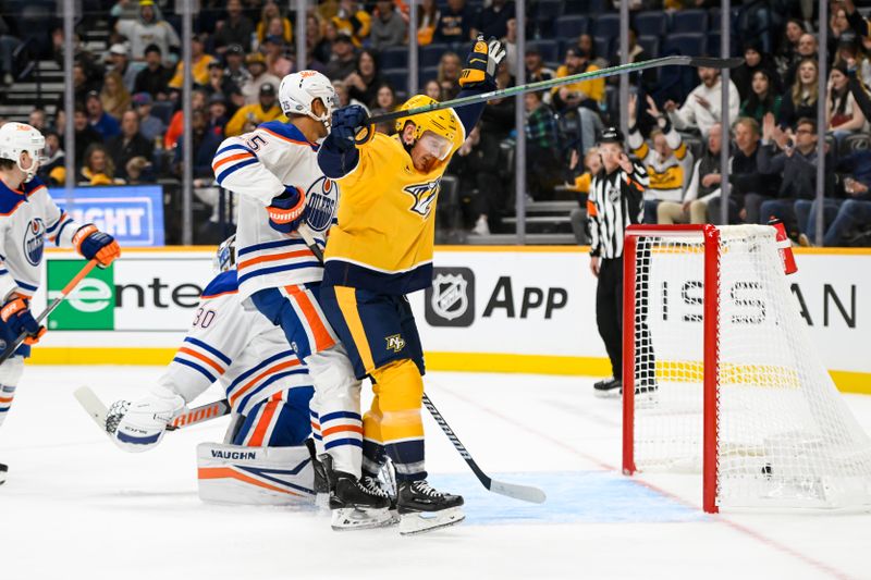 Oct 17, 2024; Nashville, Tennessee, USA;  Nashville Predators center Gustav Nyquist (14) celebrates the goal of left wing Filip Forsberg (9) against the Edmonton Oilers during the first period at Bridgestone Arena. Mandatory Credit: Steve Roberts-Imagn Images