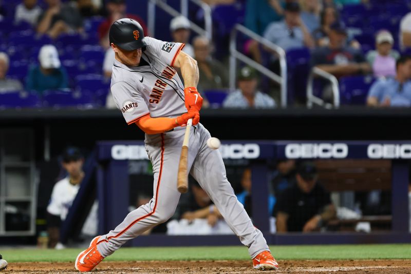 Apr 17, 2024; Miami, Florida, USA; San Francisco Giants third baseman Matt Chapman (26) hits an RBI double against the Miami Marlins during the eighth inning at loanDepot Park. Mandatory Credit: Sam Navarro-USA TODAY Sports