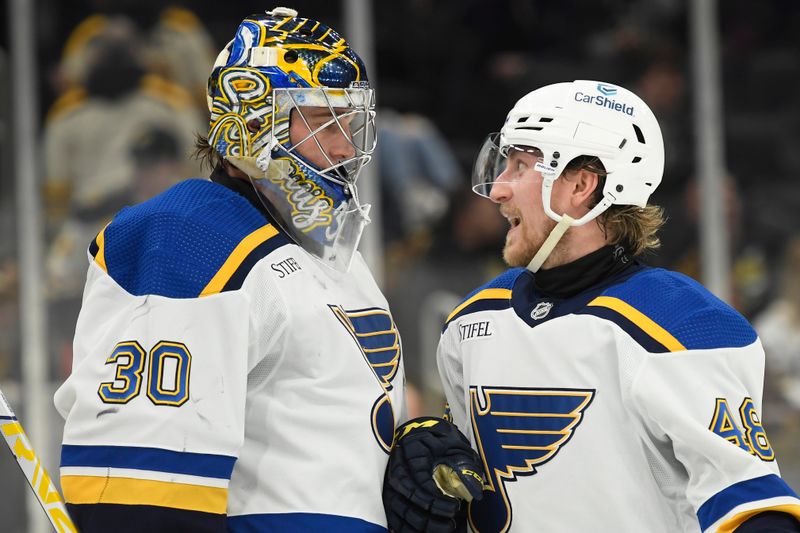 Mar 11, 2024; Boston, Massachusetts, USA;  St. Louis Blues goaltender Joel Hofer (30) and defenseman Scott Perunovich (48) react after defeating the Boston Bruins at TD Garden. Mandatory Credit: Bob DeChiara-USA TODAY Sports