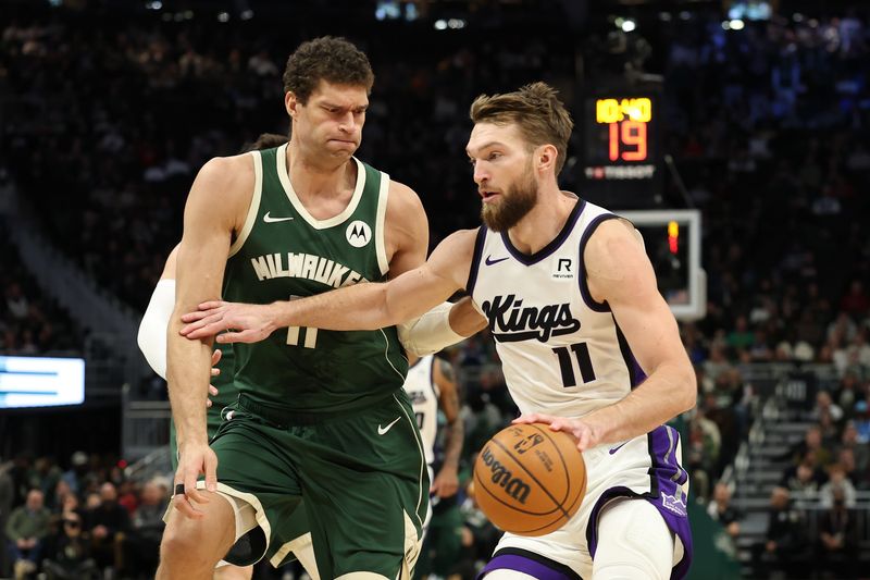 MILWAUKEE, WISCONSIN - JANUARY 14: Domantas Sabonis #11 of the Sacramento Kings is defended by Brook Lopez #11 of the Milwaukee Bucks during the second half of a game at Fiserv Forum on January 14, 2025 in Milwaukee, Wisconsin. NOTE TO USER: User expressly acknowledges and agrees that, by downloading and or using this photograph, User is consenting to the terms and conditions of the Getty Images License Agreement. (Photo by Stacy Revere/Getty Images)