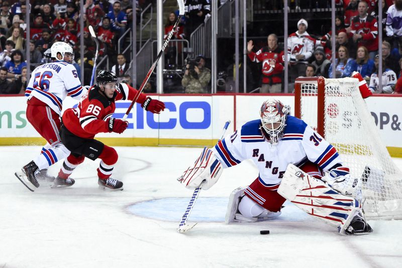 Nov 18, 2023; Newark, New Jersey, USA; New York Rangers goaltender Igor Shesterkin (31) makes a save against New Jersey Devils center Jack Hughes (86) during the second period at Prudential Center. Mandatory Credit: John Jones-USA TODAY Sports