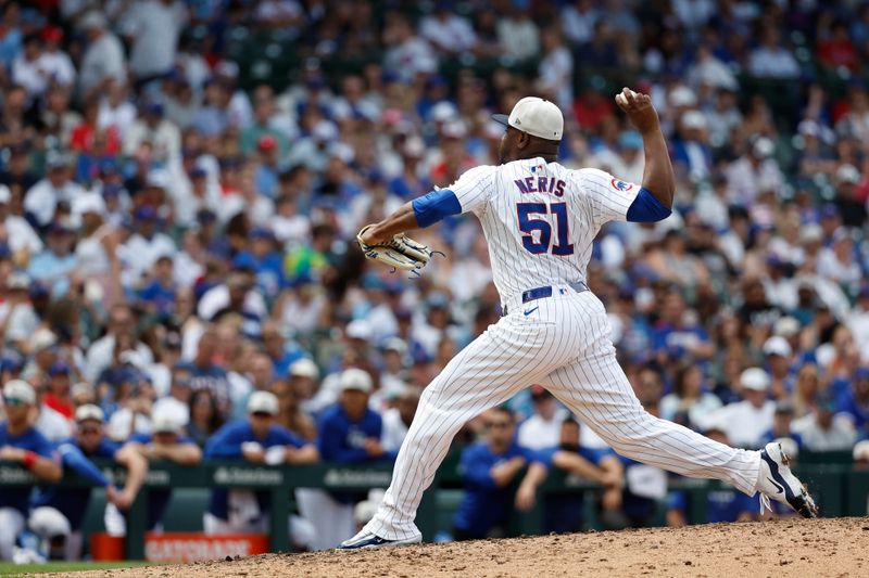 Jul 4, 2024; Chicago, Illinois, USA; Chicago Cubs relief pitcher Héctor Neris (51) delivers a pitch against the Philadelphia Phillies during the ninth inning at Wrigley Field. Mandatory Credit: Kamil Krzaczynski-USA TODAY Sports