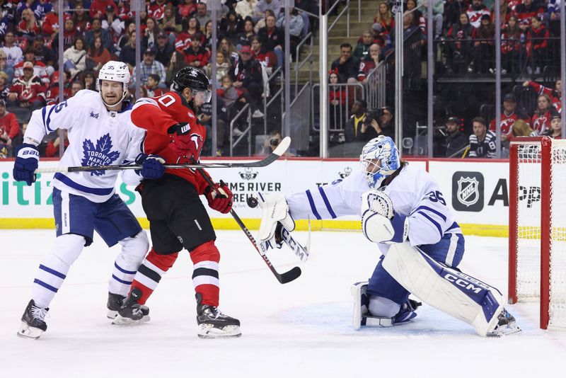 Oct 10, 2024; Newark, New Jersey, USA; Toronto Maple Leafs goaltender Dennis Hildeby (35) makes a save against the New Jersey Devils during the second period at Prudential Center. Mandatory Credit: Ed Mulholland-Imagn Images