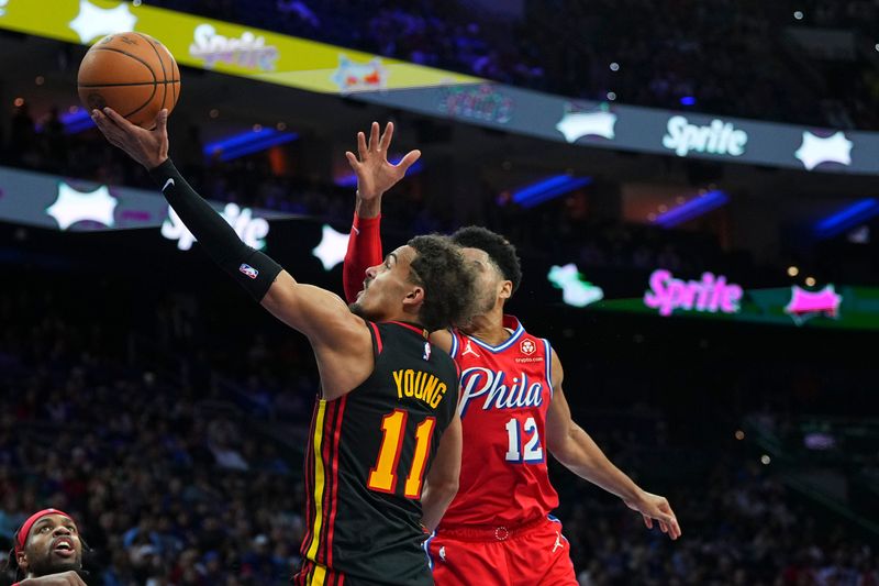 PHILADELPHIA, PENNSYLVANIA - FEBRUARY 09: Trae Young #11 of the Atlanta Hawks shoots the ball against Tobias Harris #12 of the Philadelphia 76ers in the second half at the Wells Fargo Center on February 9, 2024 in Philadelphia, Pennsylvania. The Hawks defeated the 76ers 127-121. NOTE TO USER: User expressly acknowledges and agrees that, by downloading and or using this photograph, User is consenting to the terms and conditions of the Getty Images License Agreement. (Photo by Mitchell Leff/Getty Images)