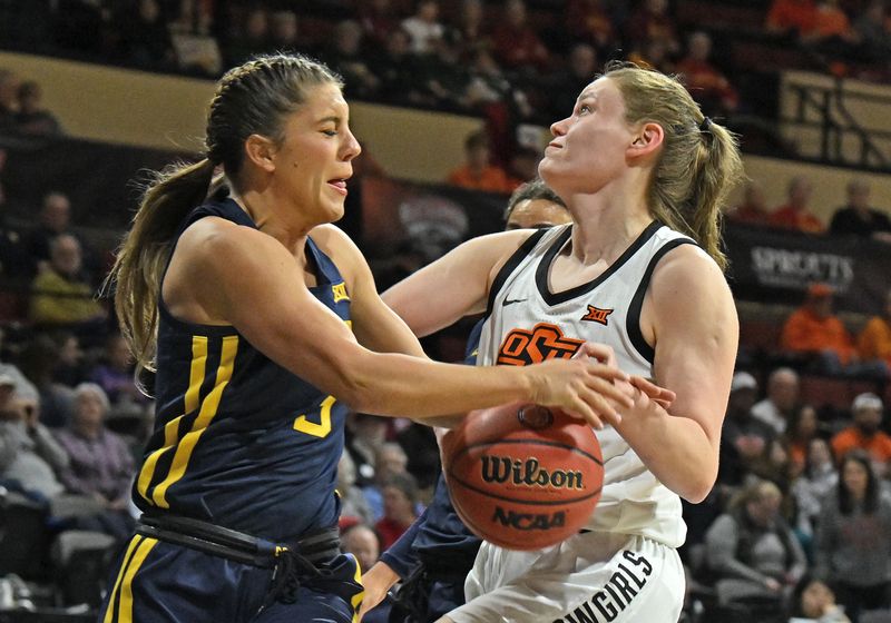 Mar 10, 2023; Kansas City, MO, USA;  West Virginia Mountaineers guard Sarah Bates (3) battles for the ball with Oklahoma State Cowgirls forward Lior Garzon (11)during the first half at Municipal Auditorium. Mandatory Credit: Peter Aiken-USA TODAY Sports