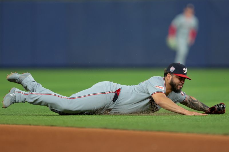 Sep 10, 2025; Miami, Florida, USA; Washington Nationals second baseman Luis Garcia Jr. (2) dives but cannot make a catch against the Miami Marlins during the fourth inning at loanDepot Park. Mandatory Credit: Sam Navarro-Imagn Images