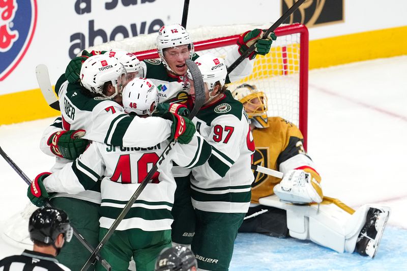 Apr 20, 2025; Las Vegas, Nevada, USA; Minnesota Wild left wing Matt Boldy (12) celebrates with team mates after scoring a goal against the Vegas Golden Knights during the third period of game one of the first round of the 2025 Stanley Cup Playoffs at T-Mobile Arena. Mandatory Credit: Stephen R. Sylvanie-Imagn Images