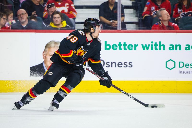 Jan 21, 2023; Calgary, Alberta, CAN; Calgary Flames left wing Jakob Pelletier (49) skates with the puck against the Tampa Bay Lightning during the third period at Scotiabank Saddledome. Mandatory Credit: Sergei Belski-USA TODAY Sports