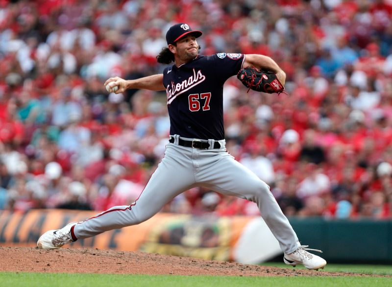 Aug 5, 2023; Cincinnati, Ohio, USA; Washington Nationals relief pitcher Kyle Finnegan (67) throws against the Cincinnati Reds during the ninth inning at Great American Ball Park. Mandatory Credit: David Kohl-USA TODAY Sports