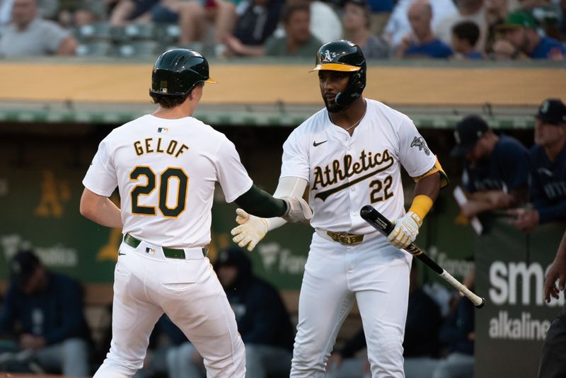 Jun 4, 2024; Oakland, California, USA; Oakland Athletics second base Zack Gelof (20) celebrates with outfielder Miguel Andujar (22) after scoring against the Seattle Mariners during the third inning at Oakland-Alameda County Coliseum. Mandatory Credit: Ed Szczepanski-USA TODAY Sports