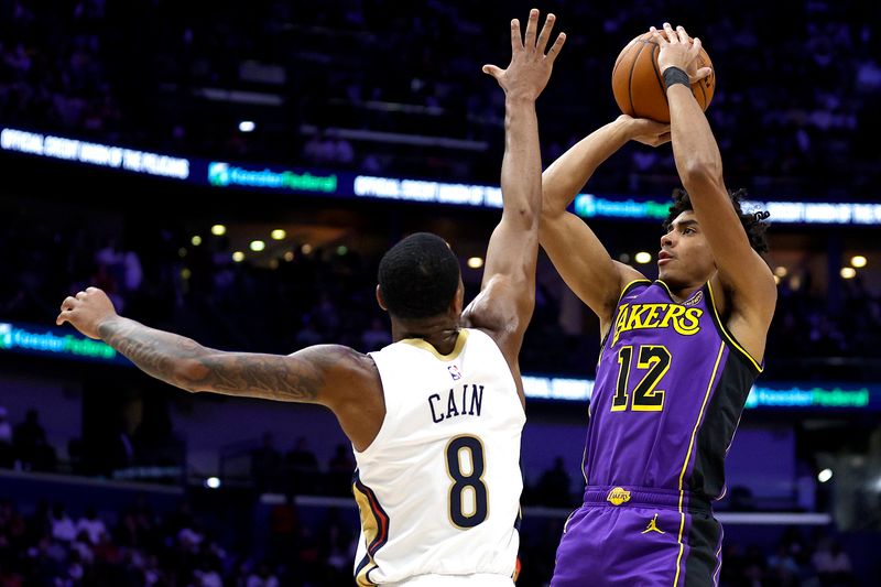 NEW ORLEANS, LOUISIANA - NOVEMBER 16: Max Christie #12 of the Los Angeles Lakers shoots over Jamal Cain #8 of the New Orleans Pelicans during the second quarter of an NBA game at Smoothie King Center on November 16, 2024 in New Orleans, Louisiana. NOTE TO USER: User expressly acknowledges and agrees that, by downloading and or using this photograph, User is consenting to the terms and conditions of the Getty Images License Agreement. (Photo by Sean Gardner/Getty Images)