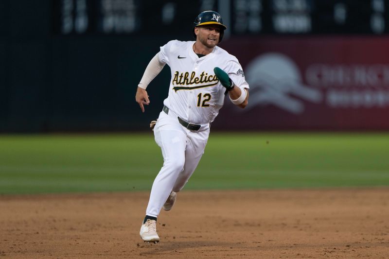 Jul 23, 2024; Oakland, California, USA;  Oakland Athletics shortstop Max Schuemann (12) runs toward third base during the sixth inning against the Houston Astros at Oakland-Alameda County Coliseum. Mandatory Credit: Stan Szeto-USA TODAY Sports