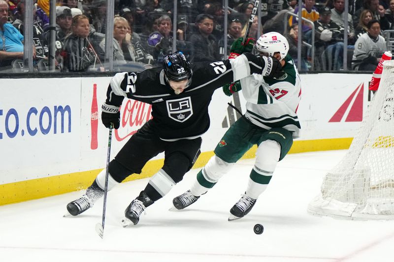 Apr 15, 2024; Los Angeles, California, USA; LA Kings left wing Kevin Fiala (22) and Minnesota Wild center Jacob Lucchini (27) battle for the puck in the third period at Crypto.com Arena. Mandatory Credit: Kirby Lee-USA TODAY Sports