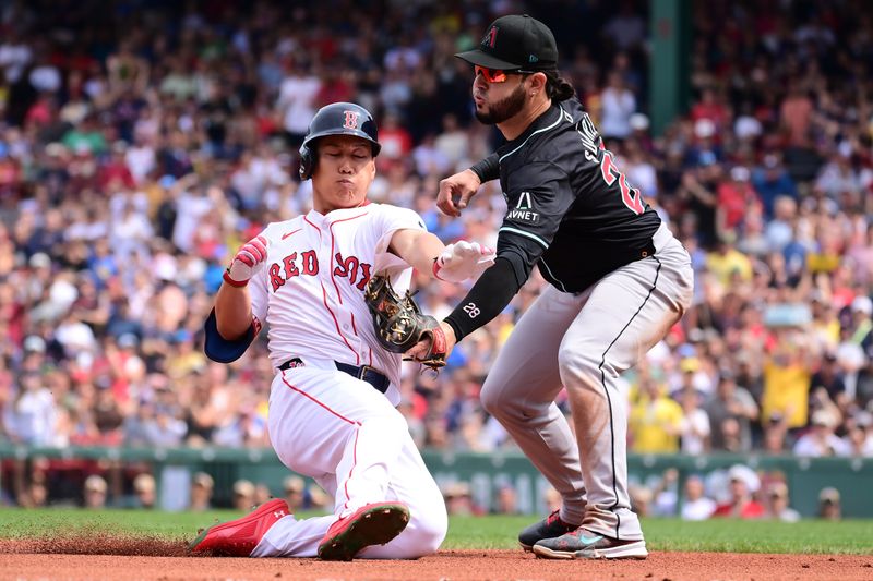 Aug 25, 2024; Boston, Massachusetts, USA; Boston Red Sox designated hitter Masataka Yoshida (7) is tagged out by Arizona Diamondbacks third baseman Eugenio Suarez (28) during the fourth inning at Fenway Park. Mandatory Credit: Eric Canha-USA TODAY Sports